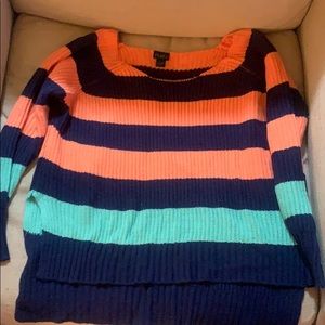Cute bright knit sweater. Long back with slits.